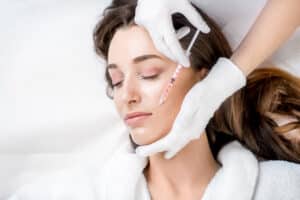 A woman getting BOTOX in her smile lines in Dallas.
